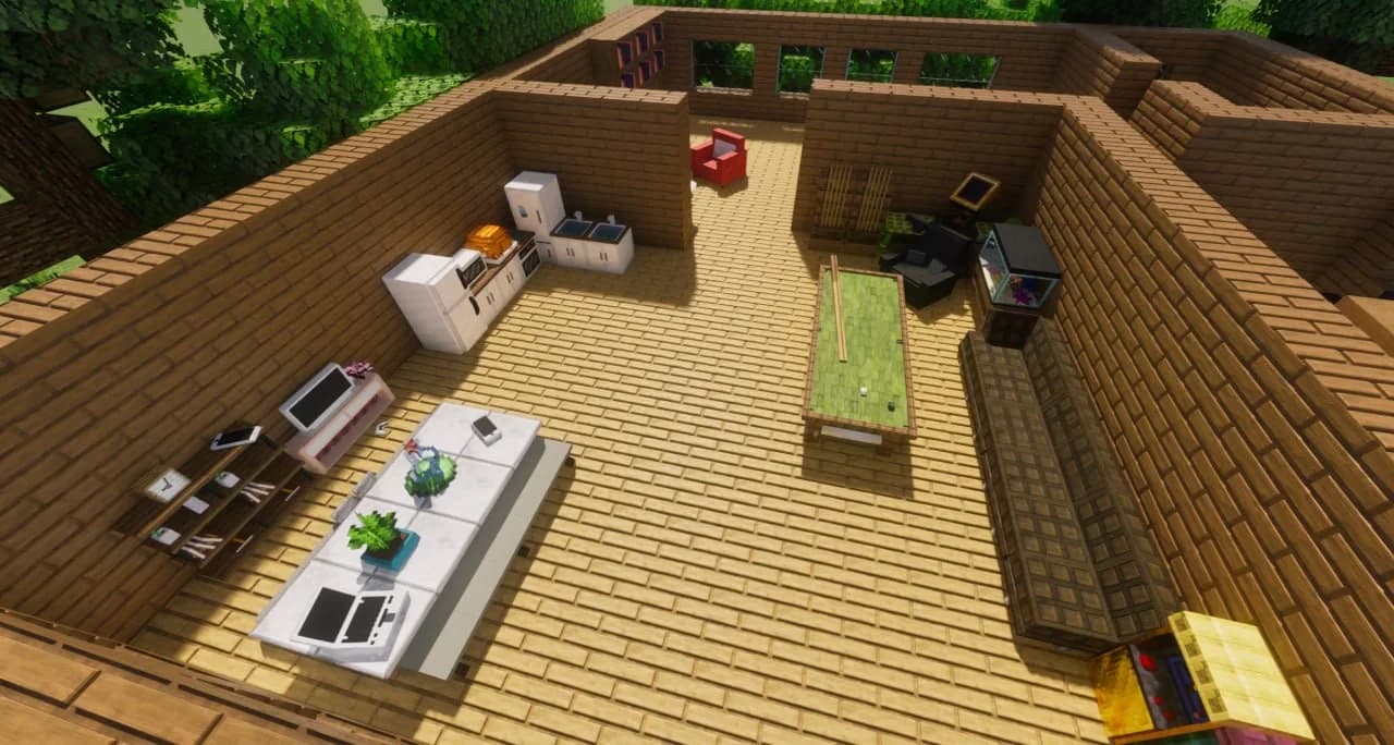 An overhead view of a furnished Minecraft home with a kitchen, living room and games room